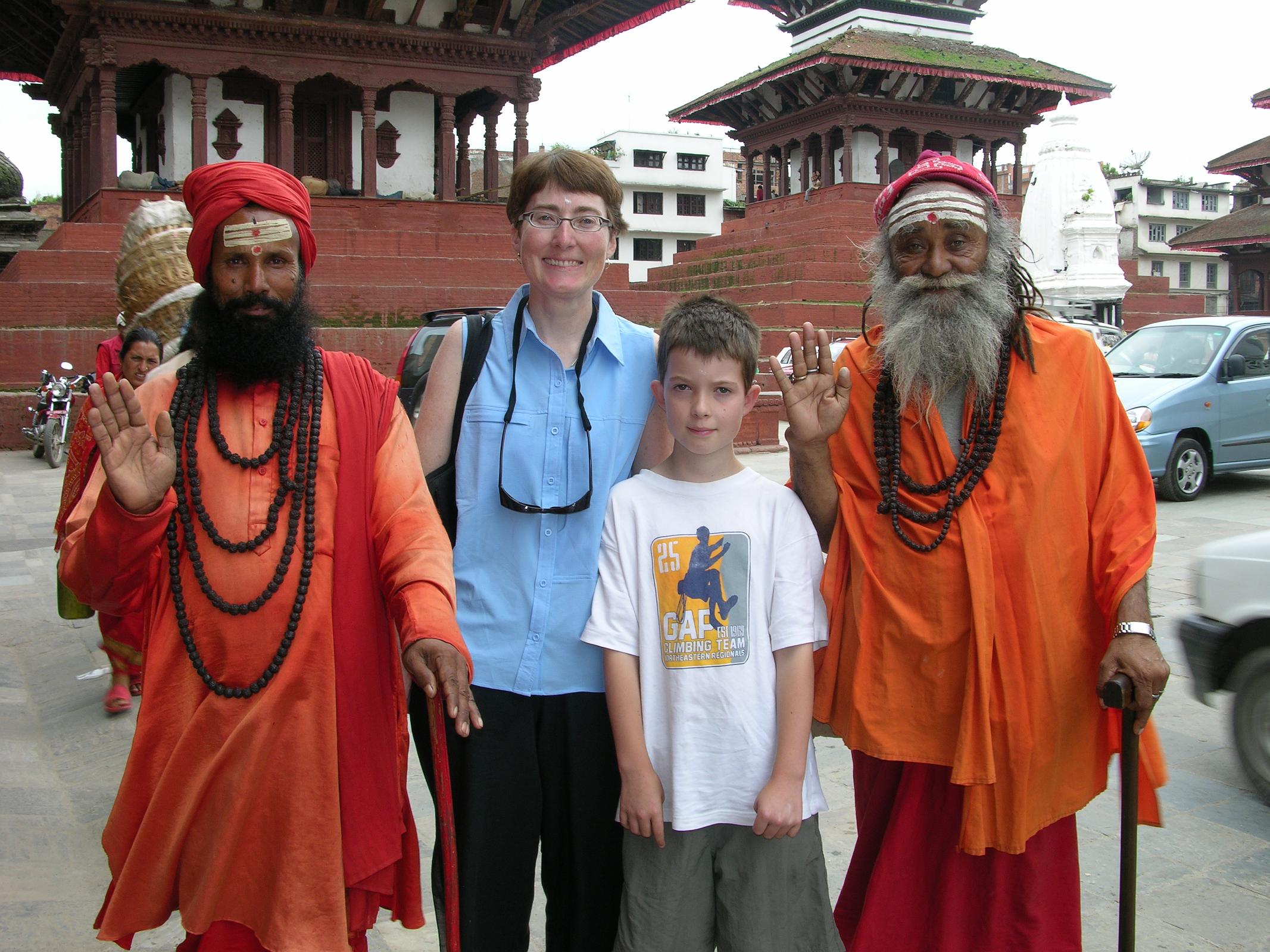 Kathmandu 02-2 Kathmandu Durbar Square Charlotte Ryan And Peter Ryan With two Hindu Sadhus Peter Ryan and Charlotte Ryan pose with two Hindu sadhus in Kathmandu's Durbar Square, with the Trailokya Mohan Narayan and Maju Deval Temples behind.